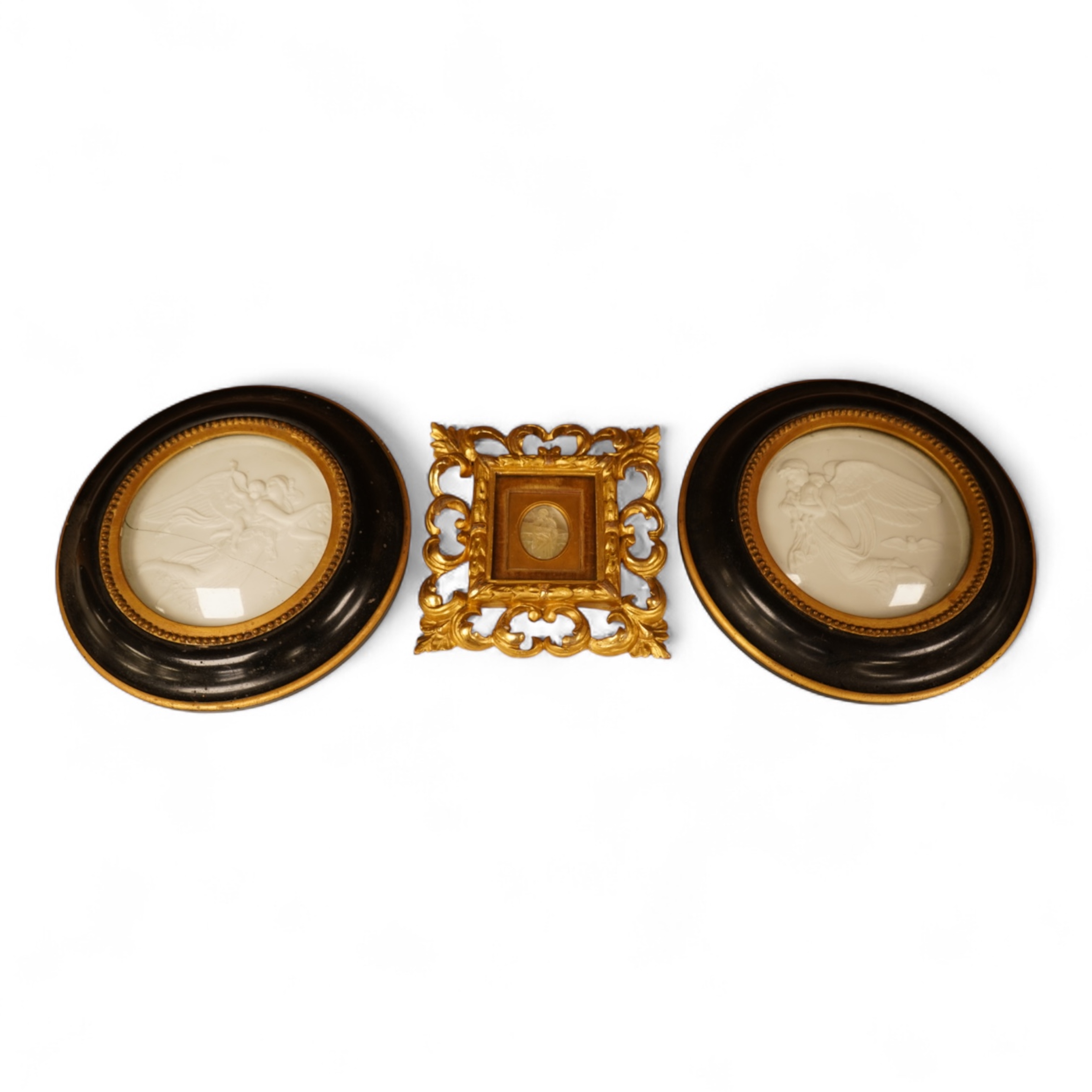 A late 19th century mother of pearl plaque of a saint, housed in a gilt wood florentine frame, together with a pair of Copenhagen biscuit porcelain plaques of Night and Day after Thorvaldsen, in convex frames